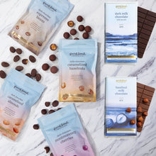 Load image into Gallery viewer, Back to School Gift Set: hazelnut milk and dark milk sea salt chocolate bars beside four pouches of chocolate-covered treats.