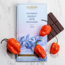 Load image into Gallery viewer, Scorpion Pepper Dark Chocolate 72% bar package on marble with fresh red scorpion peppers and unwrapped dark chocolate.
