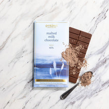 Load image into Gallery viewer, Malted Milk Chocolate 45% bar and wrapper with malt powder dusted over the chocolate and a spoonful on marble.
