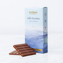 Load image into Gallery viewer, Milk Chocolate 3 Bar Collection box with blue mountain artwork and two unwrapped milk chocolate bars on white marble.

