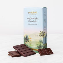 Load image into Gallery viewer, Single Origin Chocolate 3 Bar Collection box with palm tree artwork and unwrapped dark chocolate bars on marble.
